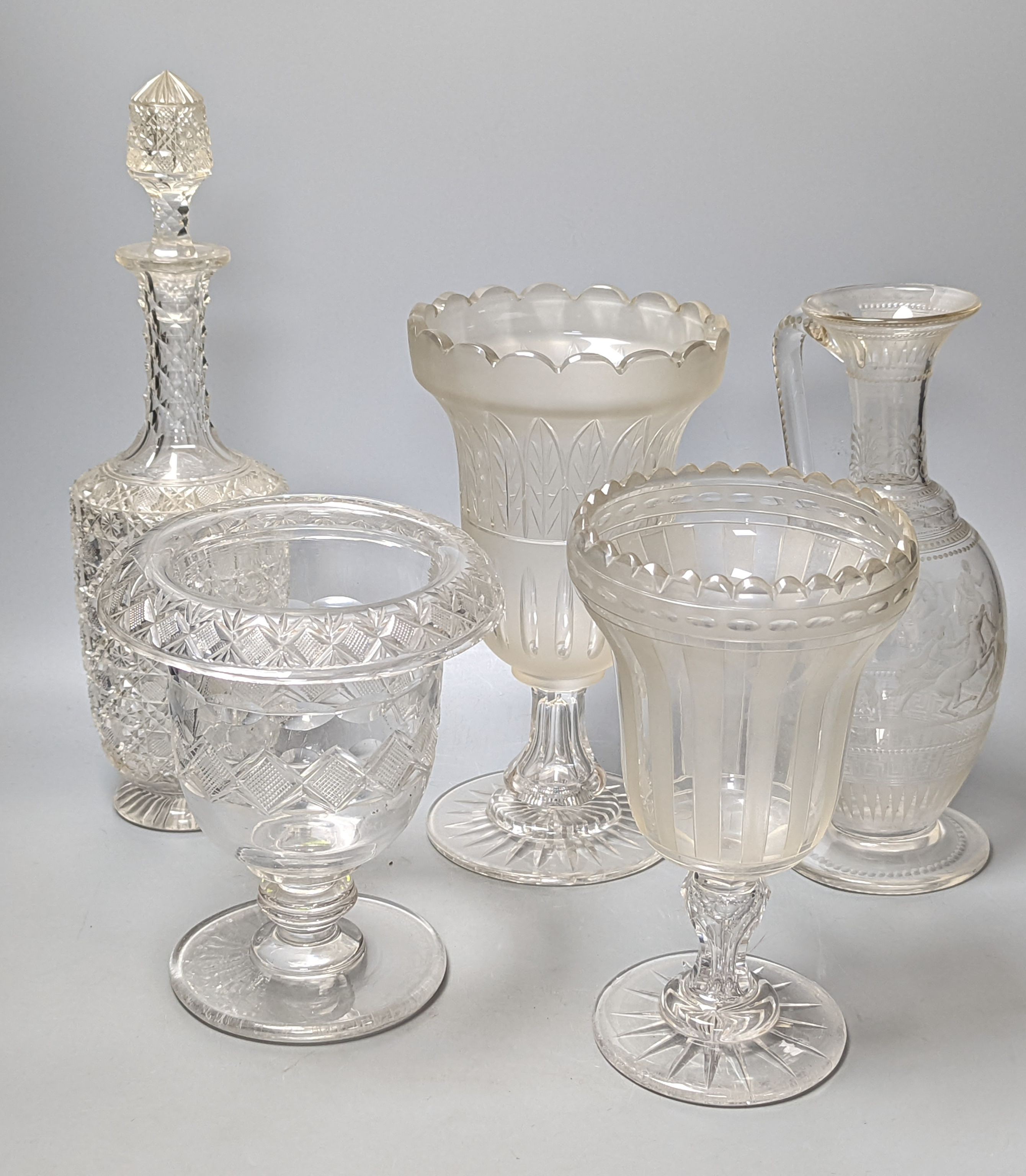 A Victorian wheel engraved ewer,with quinine scenes after the antique, 26 cms high, including 3 celery vases and a decanter.